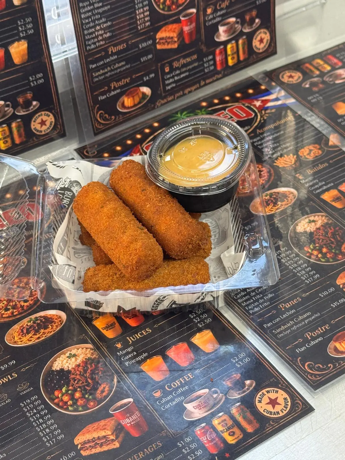 Croquetas de jamón cubanas doradas y crujientes en un plato oscuro